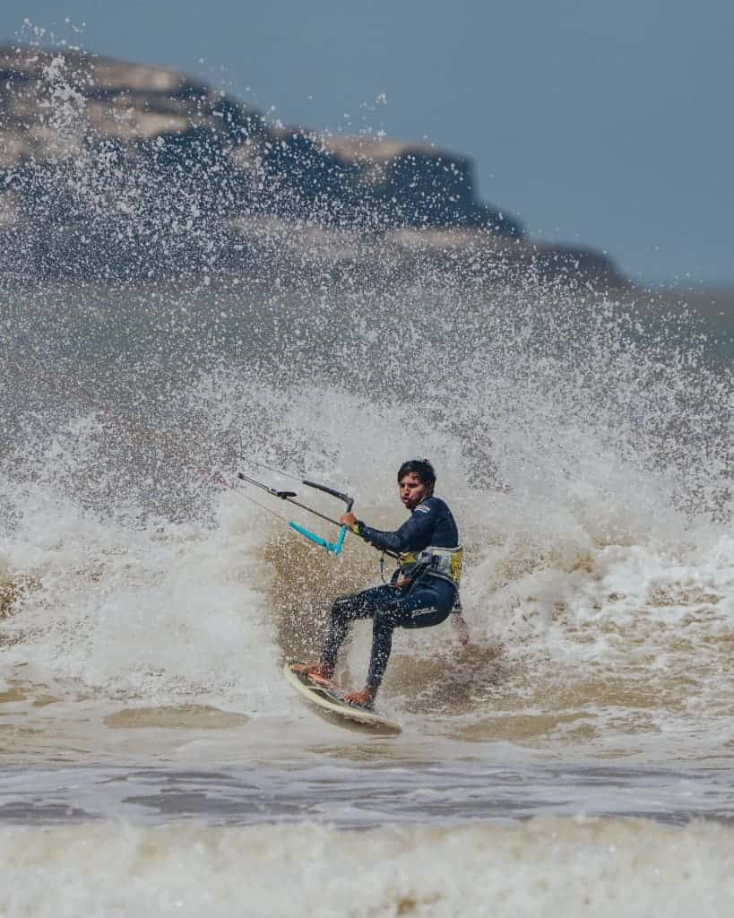 IKO kitesurf instructor carving a wave at Essaouira beach, Morocco